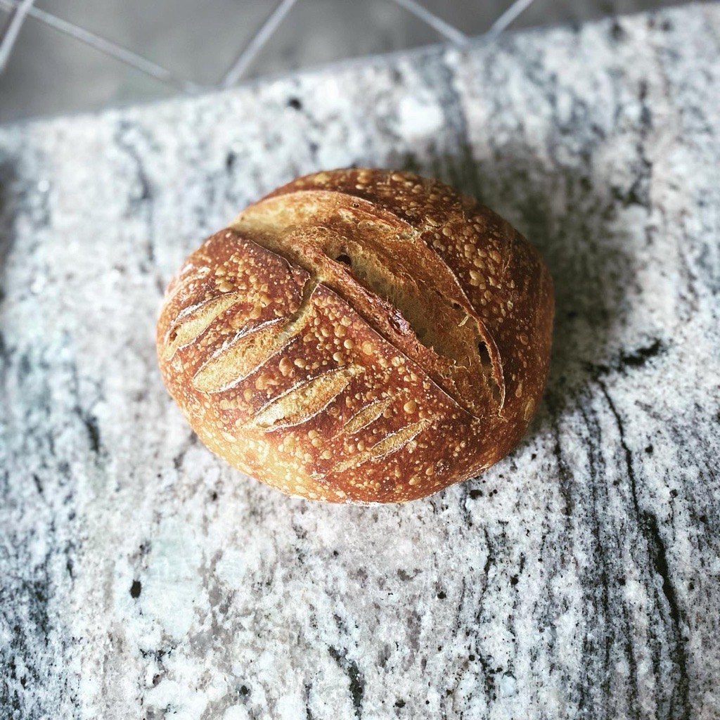 Artisan sourdough loaf with a scored, crackly crust